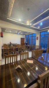 a dining room with a large wooden table and chairs at Hotel Stago Ladakh in Drās +56 photos