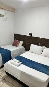 two beds in a hotel room withthritisthritislictslictslicts at Pousada Refúgio Do Cangaço in Piranhas