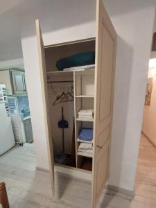 a closet with an open door in a room at Studio petite perle in Bargemon