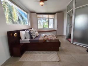 a bedroom with a bed and a large window at Crystal Apartments in Malindi