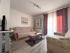 a living room with a couch and a table at Guest House Angela in Senj