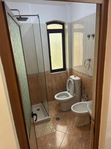 a bathroom with a toilet and a sink at Kruja Grande Hotel in Krujë +13 photos