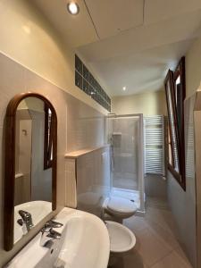 a bathroom with a sink and a toilet and a shower at Inn Venice in Venice +27 photos