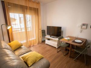 a living room with a couch and a table and a television at Casa Cesare in Cagliari