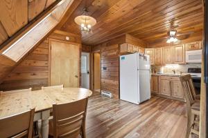 a kitchen with a table and a white refrigerator at Chalet #44 in Stevensville