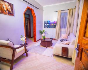 a living room with a couch and a table at JIV Luxury Homes in Mwanza