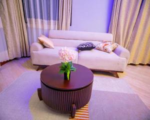 a living room with a couch and a table at JIV Luxury Homes in Mwanza