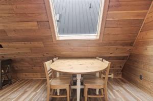 a table and chairs in a room with a window at Chalet #44 in Stevensville