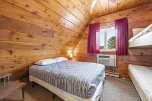 a bedroom with a bed in a wooden cabin at Chalet #39 in Stevensville