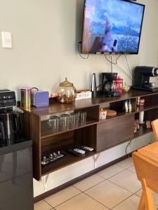 a tv on top of a wooden entertainment center at Casa de Melinka in Mejillones