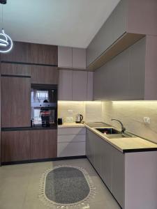 a kitchen with a sink and a counter top at Apartment N6 Shkoder in Shkodër