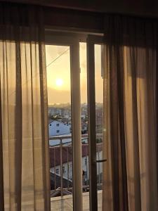 a room with a window with a view of a city at Apartment N6 Shkoder in Shkodër
