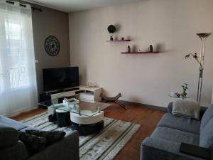 a living room with a couch and a coffee table at BERGERAC Chez Béa in Bergerac