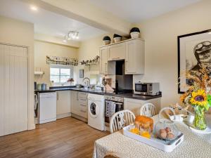 a kitchen with a table and a dining room at 2 Bed in Wincle oc-pk298 in Windley