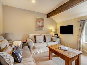 a living room with a couch and a table at 2 Bed in Wincle oc-pk298 in Windley