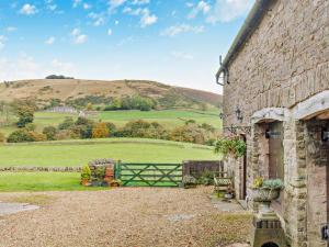 a stone house with a gate and a field at 2 Bed in Wincle oc-pk298 in Windley