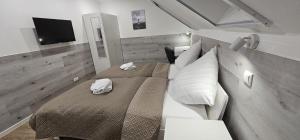 a bedroom with two beds and a flat screen tv at Gästehof Bützfleth in Stade