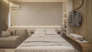 a bedroom with a large bed and a chair at NOEMA Fanari in Fanari