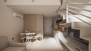a living room with a staircase and a table and chairs at NOEMA Fanari in Fanari