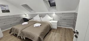 a bedroom with a large bed with white pillows at Gästehof Bützfleth in Stade