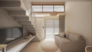a living room with a couch and a tv at NOEMA Fanari in Fanari