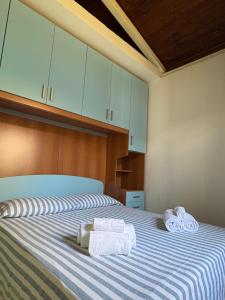 a bedroom with a bed with two towels on it at Soleada Club in Campofelice di Roccella +36 photos