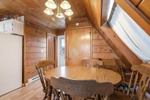 a dining room with a wooden table and chairs at Chalet #29 in Stevensville +34 photos
