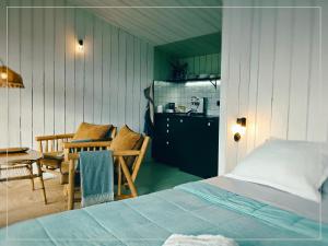 a bedroom with a bed and a table and chairs at La Pause En Soi - Cabanes climatisées avec Jaccuzi privatif en option in Ponlat-Taillebourg