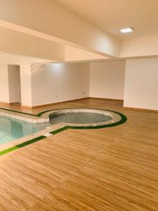 a large empty room with a pool in the middle of the floor at Luxury Studio Apartment in Ilado