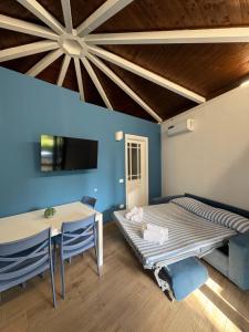 a bedroom with a bed and a table and chairs at Soleada Club in Campofelice di Roccella