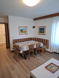 a dining room with a table and chairs at Campiglio Trilocale Monte Spinale in Madonna di Campiglio +20 photos