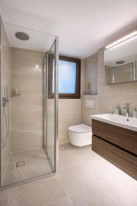 a bathroom with a shower and a toilet and a sink at Thalia Luxury Apartment in Samos +15 photos