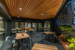 a patio with tables and chairs in a restaurant at Central Hotel in Ferizaj