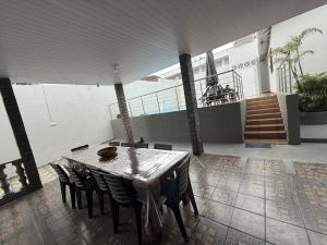 a table and chairs in a room with a building at Casarão Figueiredo in Presidente Figueiredo