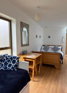 a bedroom with a bed and a table and a bench at The Apple Tree in Chestfield