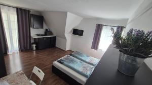 a small living room with a table and a couch at Motel Graz Ost I Free Parking I Self Check-in in Graz