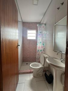 a bathroom with a toilet and a sink at Hotel Interlagos Plaza in São Paulo