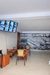 a room with chairs and a tv on the wall at Hotel Interlagos Plaza in São Paulo