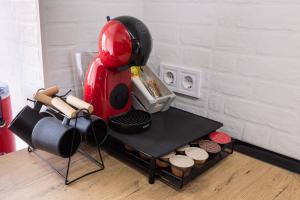a red coffee maker on a table in a kitchen at REFUGIO De PERNACIO in Ávila