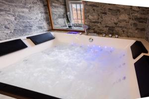 a bath tub filled with water in a room at REFUGIO De PERNACIO in Ávila +9 photos