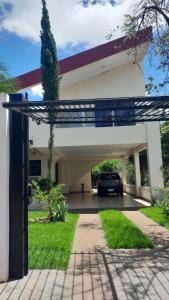a garage with a car parked in a driveway at Alojamiento LA PERSEA in Encarnación