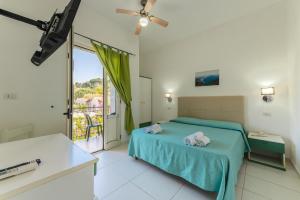 a bedroom with a bed and a large window at Hotel Ulisse in Palinuro +43 photos
