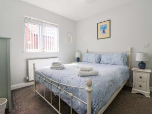 a bedroom with a bed with towels on it at Southview Bungalow in Barmston
