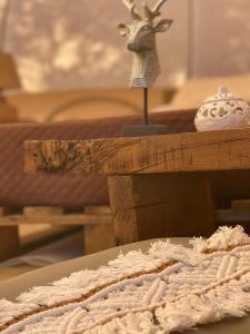 a table with a blanket and a figurine on top at Golden Camp in Falerna