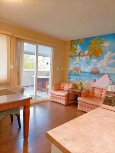 a living room with a painting of the ocean at Cozy Home in Vancouver in Vancouver