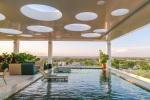 a swimming pool on the roof of a building at Monã Hotel in Teresina