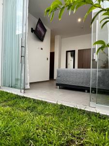 a bedroom with a bed and a tv on the wall at Residencia Privé in Ica