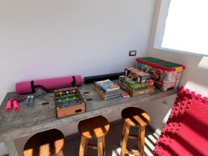 a room with a table with chairs and toys at Residencia Privé in Ica