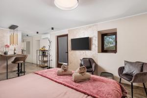 a bedroom with a large bed with two dolls on it at SROK luxury apartments by the pool in Kastav