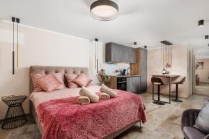 a bedroom with a large bed with a red blanket at SROK luxury apartments by the pool in Kastav +78 photos